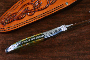 "Malaka" fine custom handmade knife. spine and tapered tang detail  in hand-engraved CPM 154CM powder metal technology stainless steel, T4 deep cryogenically treated, bolsters of hand-engraved 304 stainless steel, Plasma agate and Nephrite Jade gemstone handle, hand-carved leather crossdraw sheath with stainless steel hardware